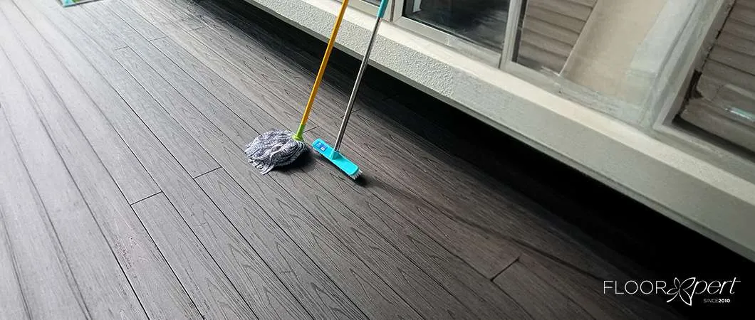 A Person Cleaning the Outdoor Balcony of Their Home with a Broom