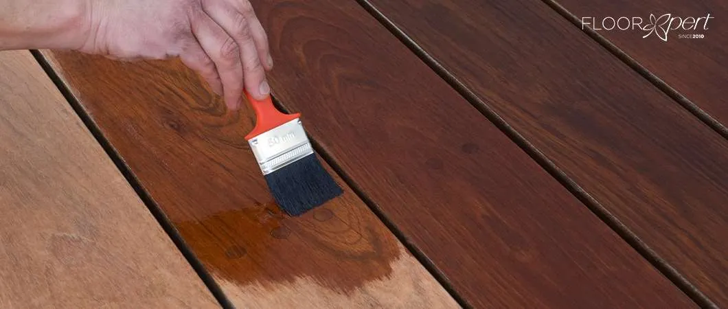 Applying oil to a wooden deck