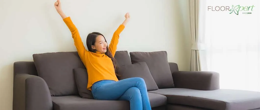 A Happy Woman While Sitting In The Sofa
