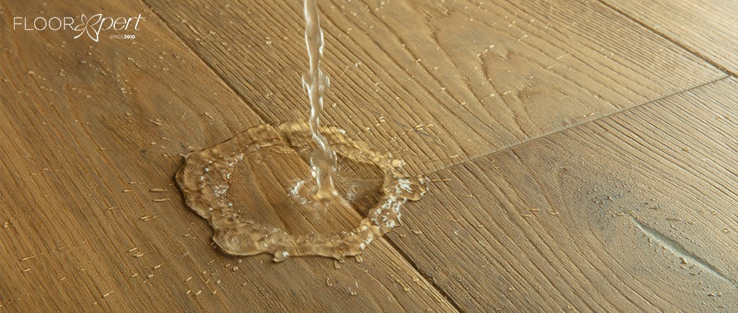 water spilling onto engineered wood flooring surface
