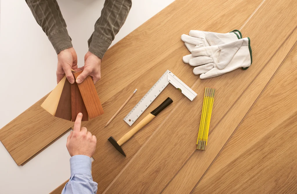 Specialist reviewing wood flooring samples for HDB BTO and resale homes in Singapore - Floor Xpert