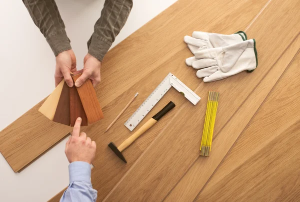 Specialist reviewing wood flooring samples for HDB BTO and resale homes in Singapore - Floor Xpert