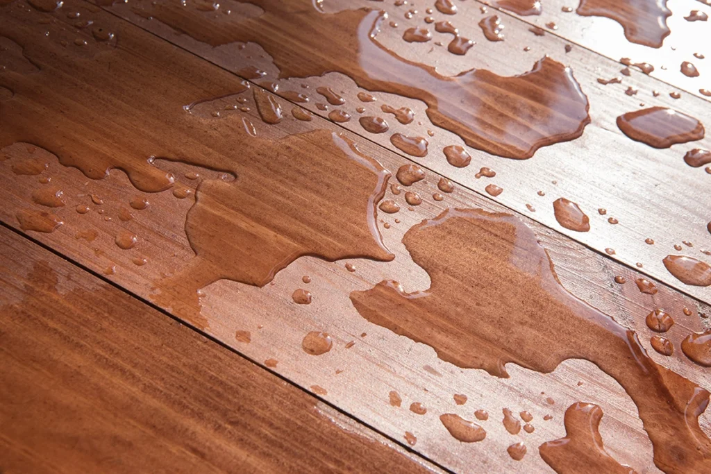 Wet vinyl wood flooring in Singapore showing how sealed joints and perimeter protection help resist standing water - Floor Xpert